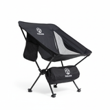 Black camping chair with carrying bag on a white background